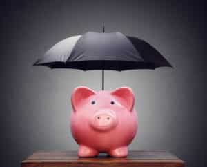 Piggy bank with umbrella concept for rainy day fund