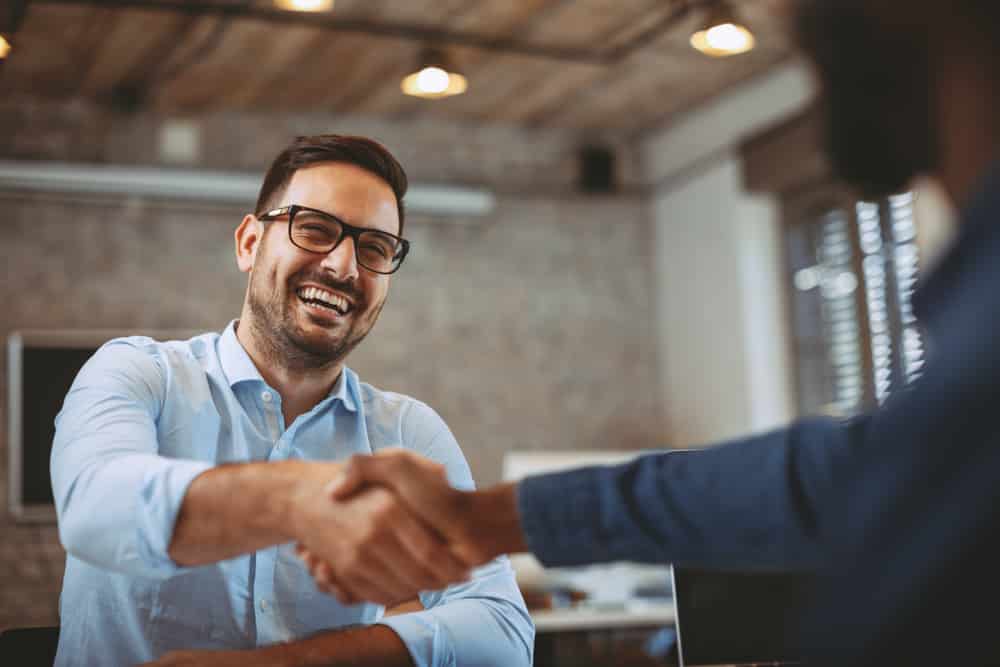 business man shaking hands after a deal