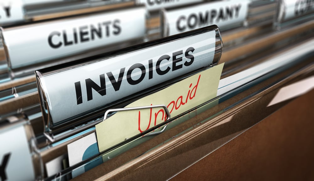invoice folder with a note that says unpaid